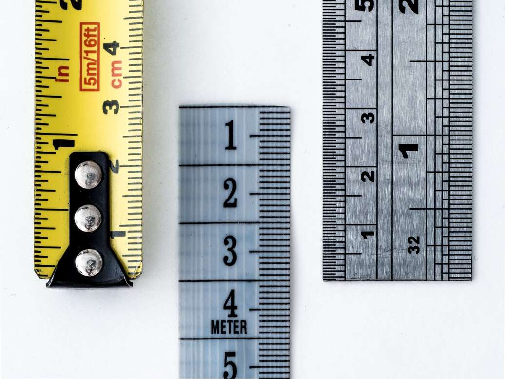 Three rulers of varying colors side by side